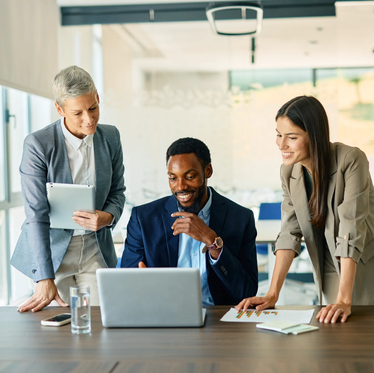Colleagues discussing work at desk